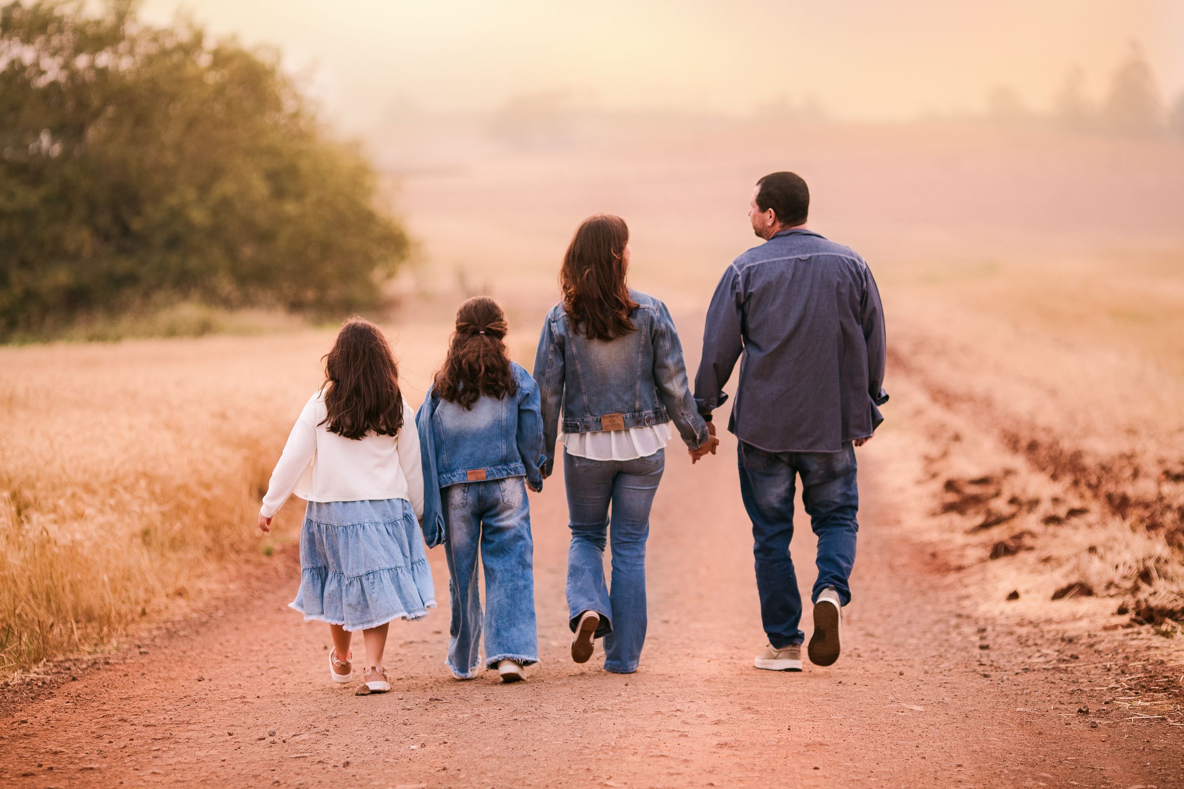 A family walking together along a country track in the late afternoon light